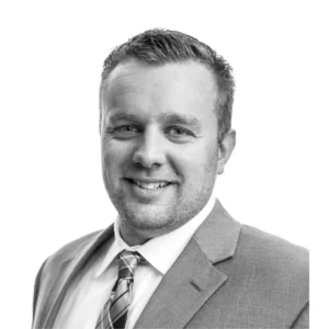 Professional headshot of Brian Dries wearing a suit and smiling.