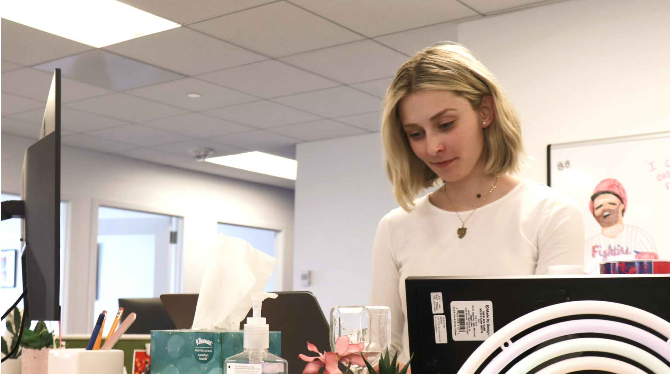 Samra Smajlovic stands at her desk in Philadelphia working on her laptop