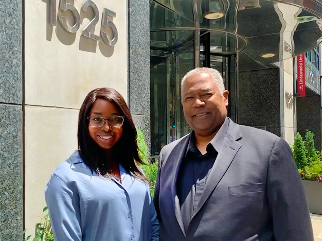 A Black man and woman stand together outside a building in Philadelphia