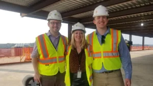 Pittsburgh staff members Keegan Gibson, Amanda Mueller and Joey Georgy in construction gear for a client event