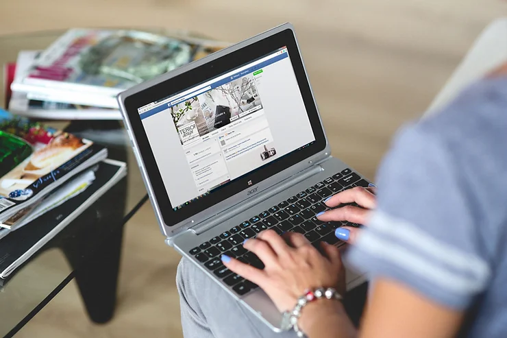 Woman with laptop on her lap