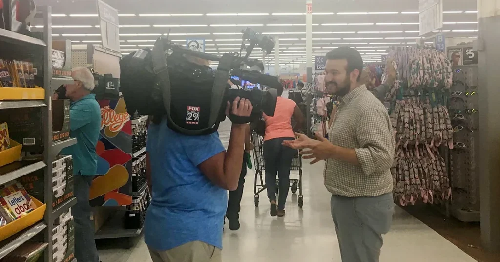 A news crew interviews people in a store