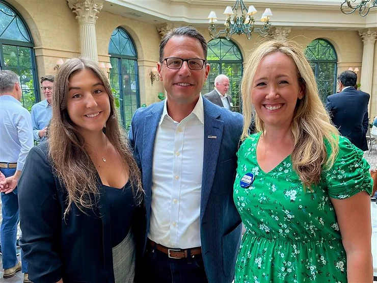 Meredith Montalto and Corinne Ahrens pose for a photo with Josh Shapiro at a summer event