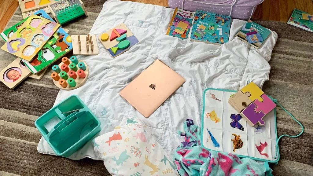 Shannon Wink's Apple laptop sitting on top of her daughters' play mat surrounded by toys