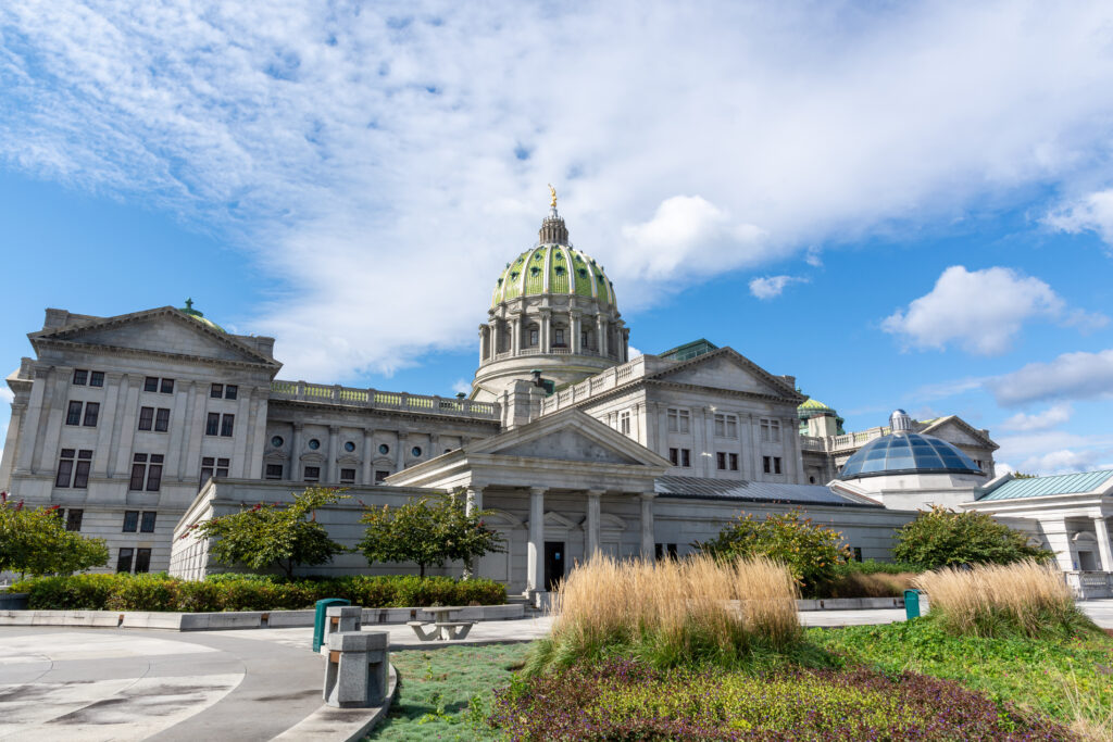 Autumn morning light on the Pennsylvania State Capitol East Wing in Harrisburg, Pennsylvania. Garden in foreground.